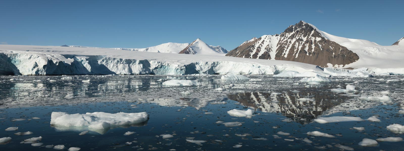 Mirror image of ice and mountains, Antarctica Mirror image of ice and mountains in Antarctica onboard Ocean Nova expedition cruise