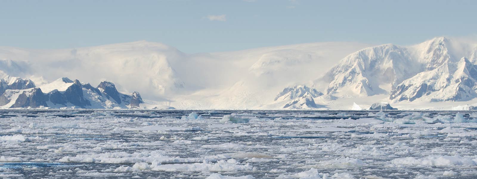 Bay with brash ice with snowy mountains in Antarctica Bay filled with brash ice with snowy mountains of Antarctica in background