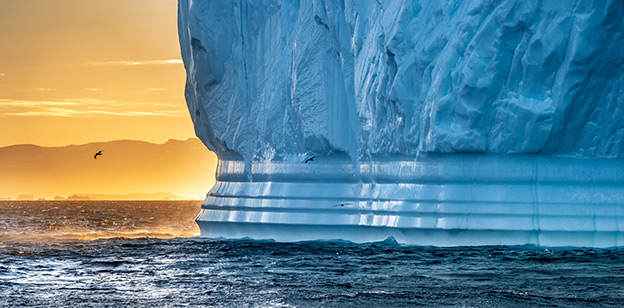giant iceberg at sunset
