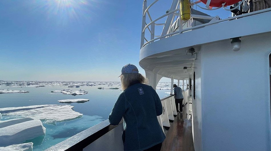 MS Sjoveien - Guest out on deck sailing in the Arctic 