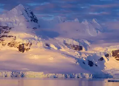 Snow-covered mountains in the background at sunrise in Antarctica