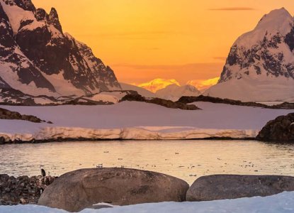 Sunset on snowy Antarctic landscape 