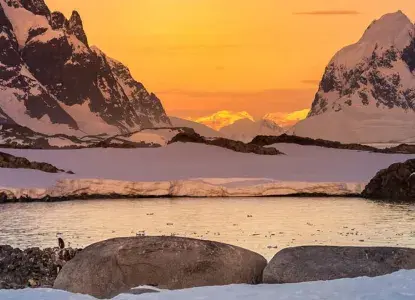 Sunset on snowy Antarctic landscape 