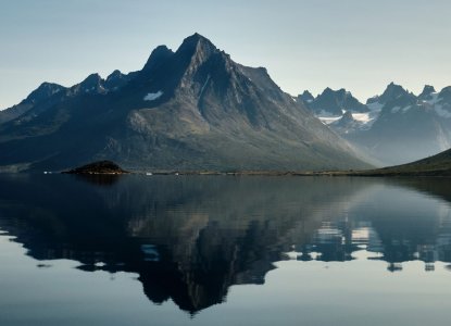 Still water reflection of a bay in Tesermiut Greenland